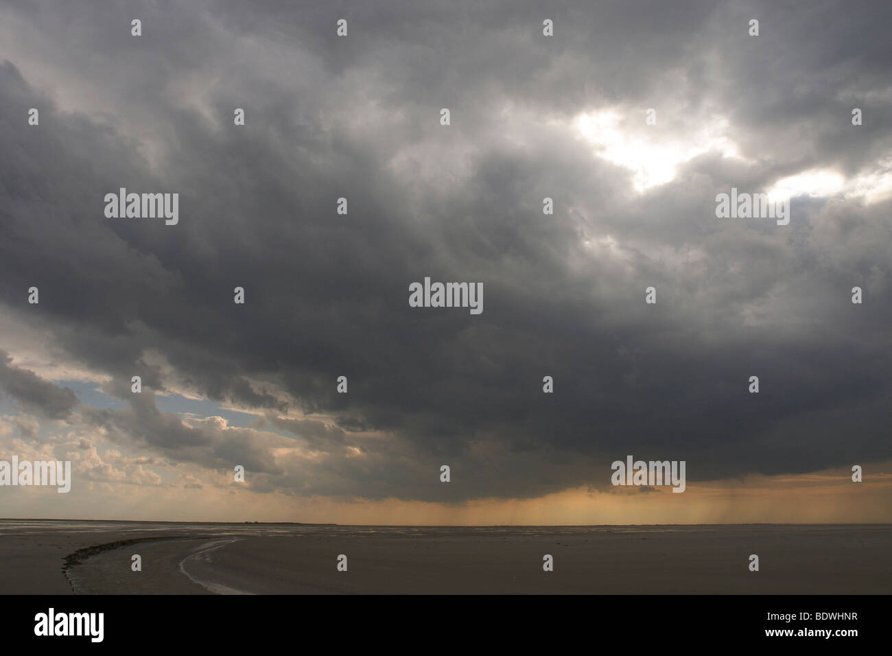 Dark clouds, tidal creek on the North Sea island of Juist, Lower Saxony, Germany, Europe Stock Photo