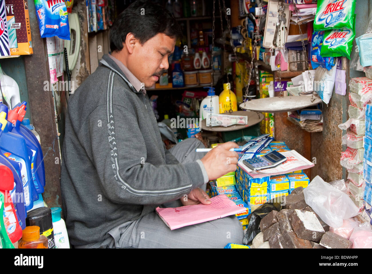 Kathmandu, Nepal. Shopkeeper Doing his Accounts. Stock Photo