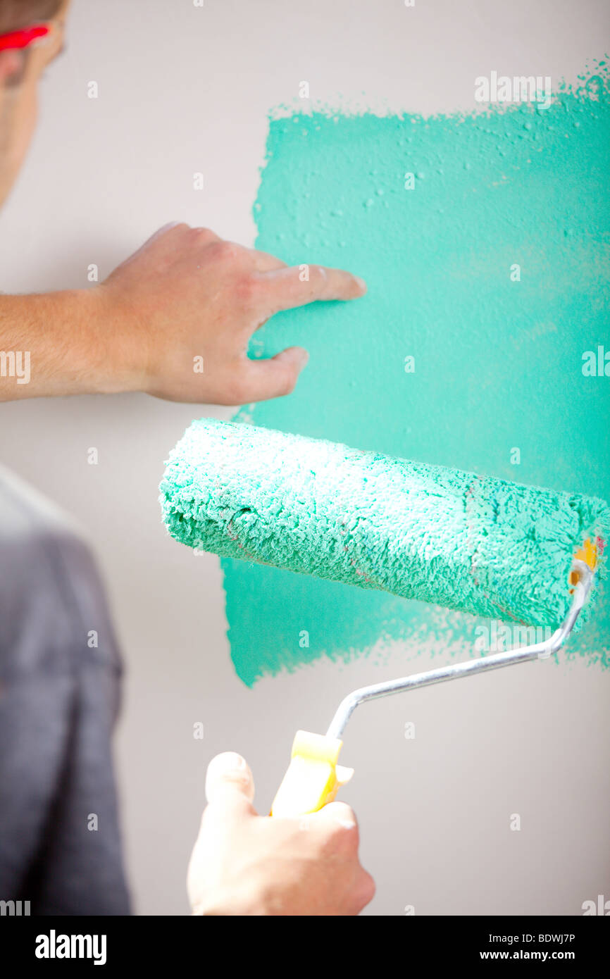 Roller paint the walls green Stock Photo - Alamy