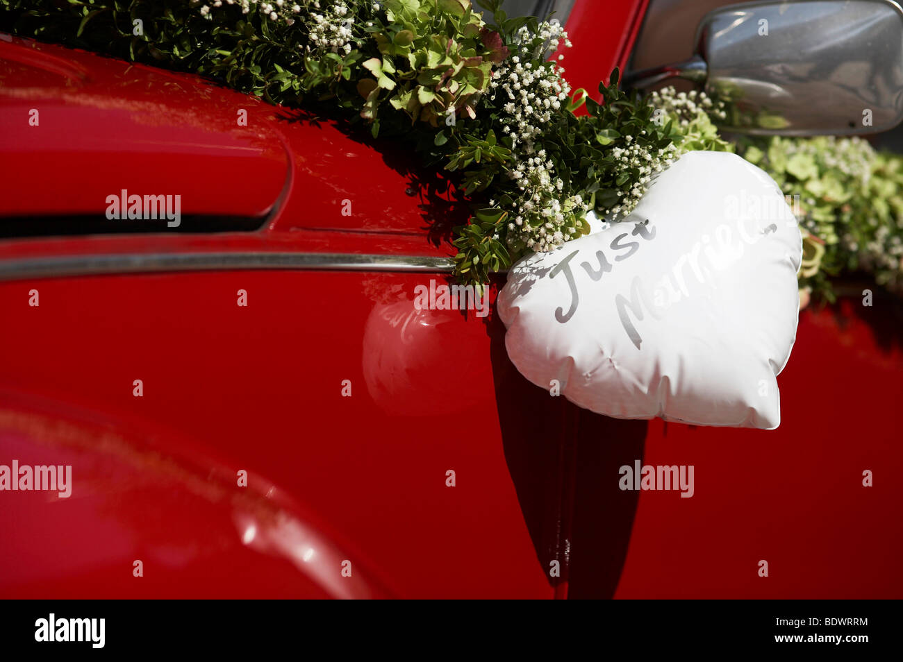 Red VW beetle with a white heart, wedding car Stock Photo
