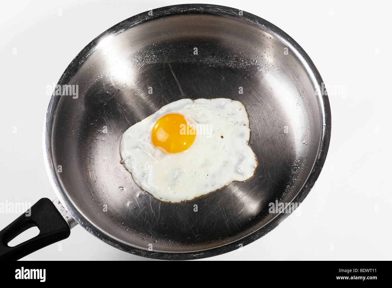 Fried egg in a metal pan Stock Photo