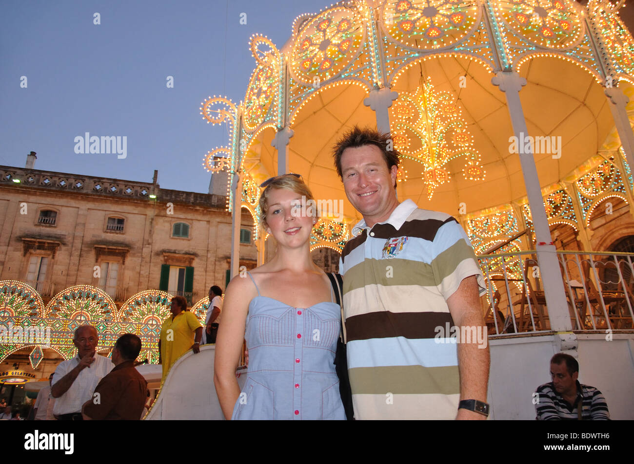 Couple by bandstand, Cavalcata di Sant Oronzo, Piazza della Liberta, Old Town, Ostuni, Brindisi Province, Puglia Region, Italy Stock Photo