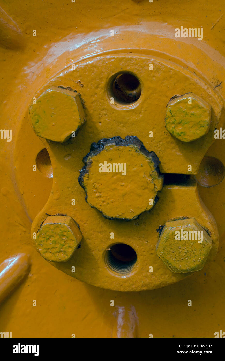 Closeup of wheel nuts on an old yellow tractor Stock Photo Alamy