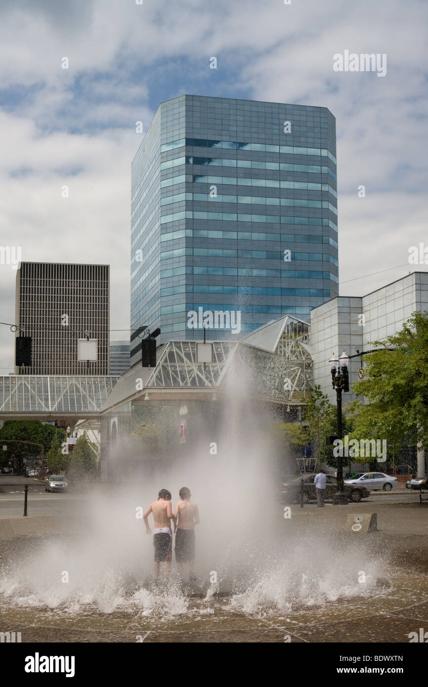 Boys running through fountain at Tom McCall Waterfront Park in Portland, Oregon Stock Photo