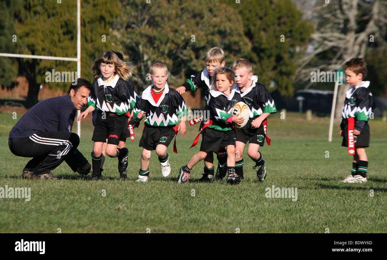Young girls and boys play rugby union in New Zealand Stock Photo