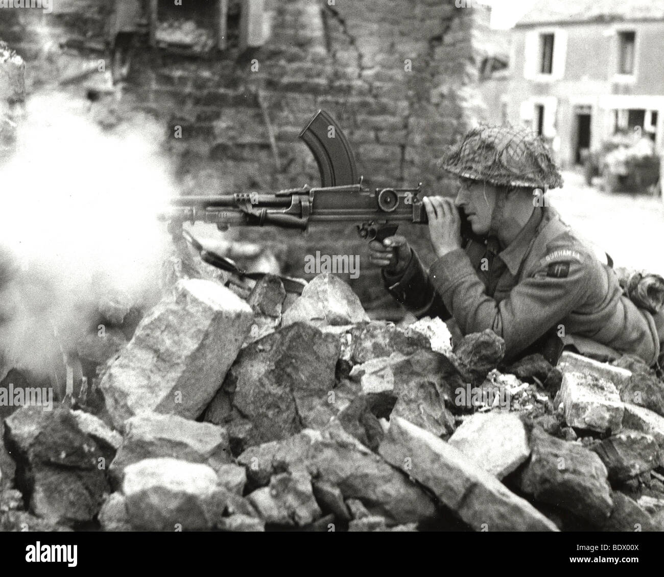 BRITISH BREN GUNNER in the ruins of a house during the advance after 6 June 1944 landings in Normandy Stock Photo