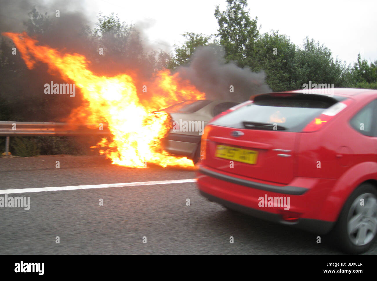 CAR FIRE - Blazing car on the M40 in England Stock Photo
