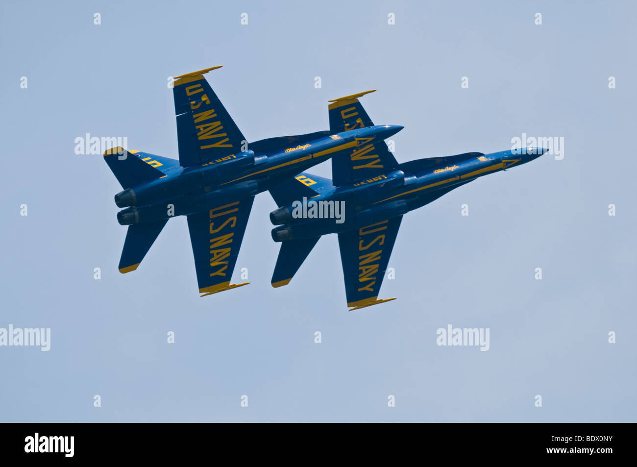 Two members of the US Navy's Blue Angels Demonstration Squadron flying Boeing F/A-18 Hornet fighter jets in tight formation. Stock Photo