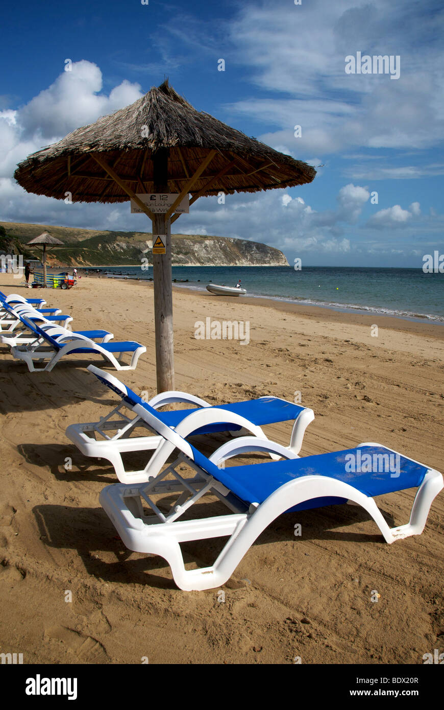 Swanage Beach Private Dorset UK Beach Sea Sand Sun Loungers Thatched Shades Stock Photo