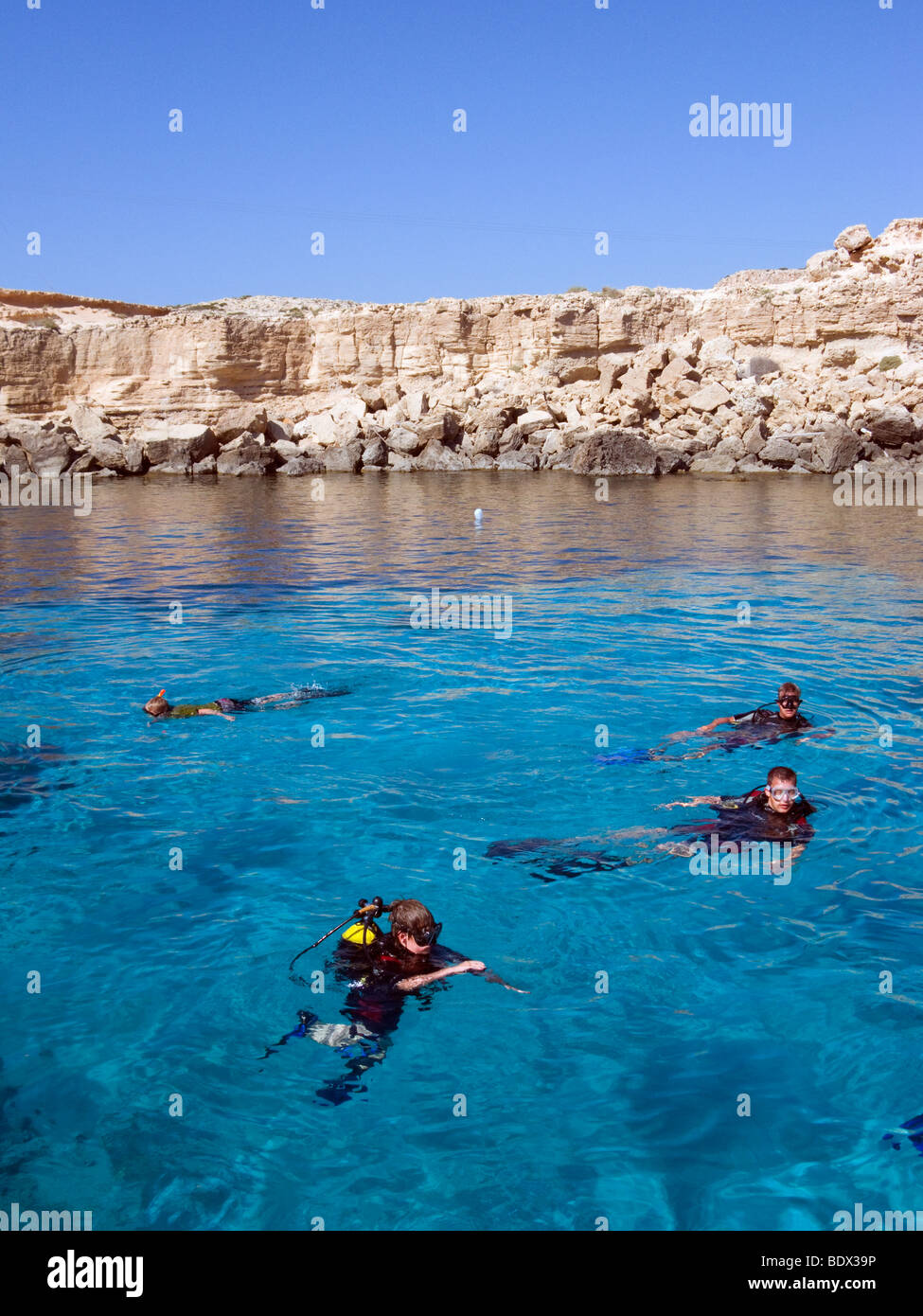 Scuba diving tourists at the Blue Lagoon, Cape Greco, Cyprus. This is a very popular scuba place due to crystal clear water. Stock Photo