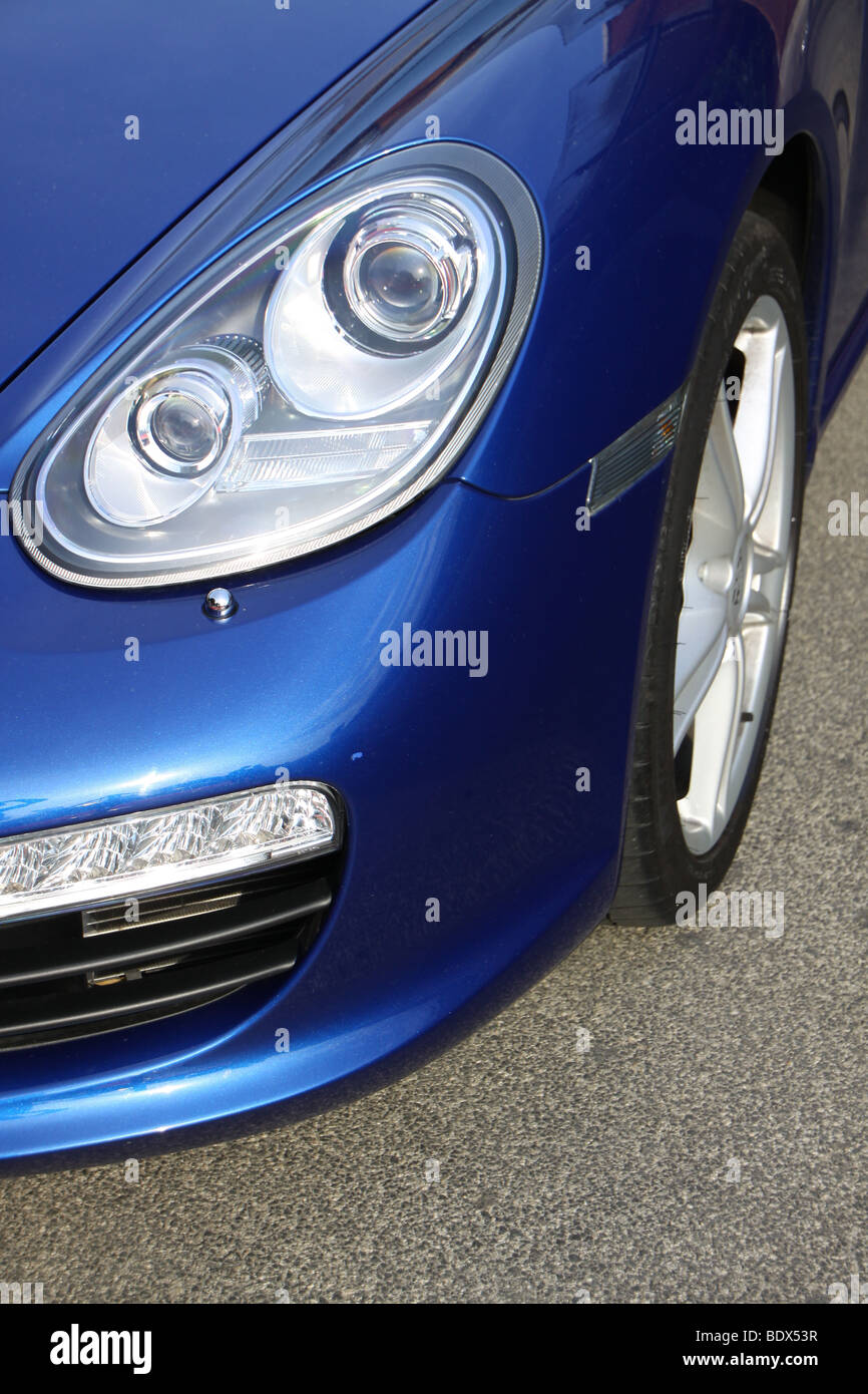 Headlamp of a blue Porsche Boxster S Stock Photo