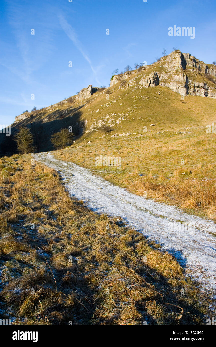 A Limestone Crag against a blue sky above Ricklow Dale at the head of Lathkill Dale in Derbyshire Stock Photo