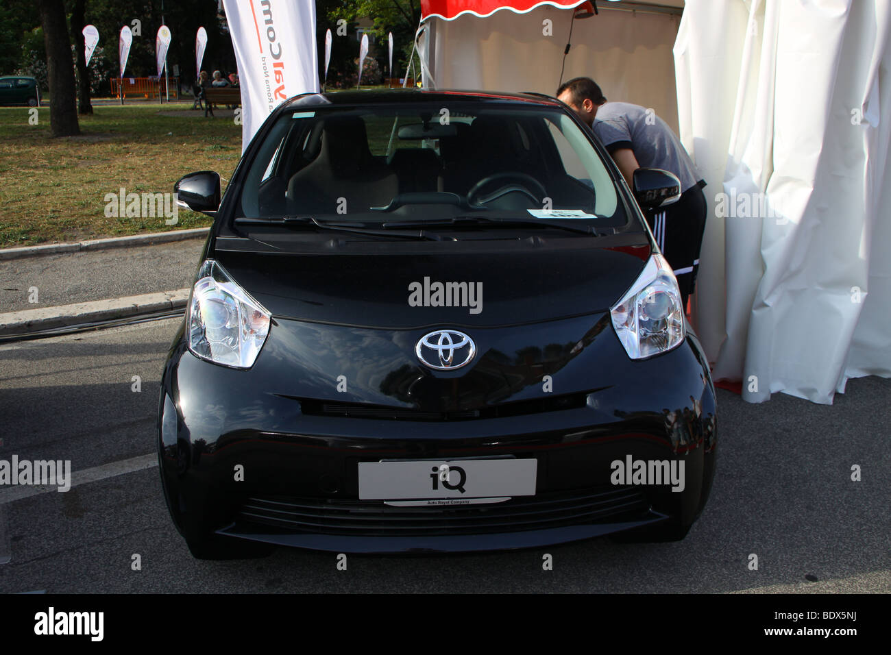 Man looking at Black Toyota IQ Stock Photo