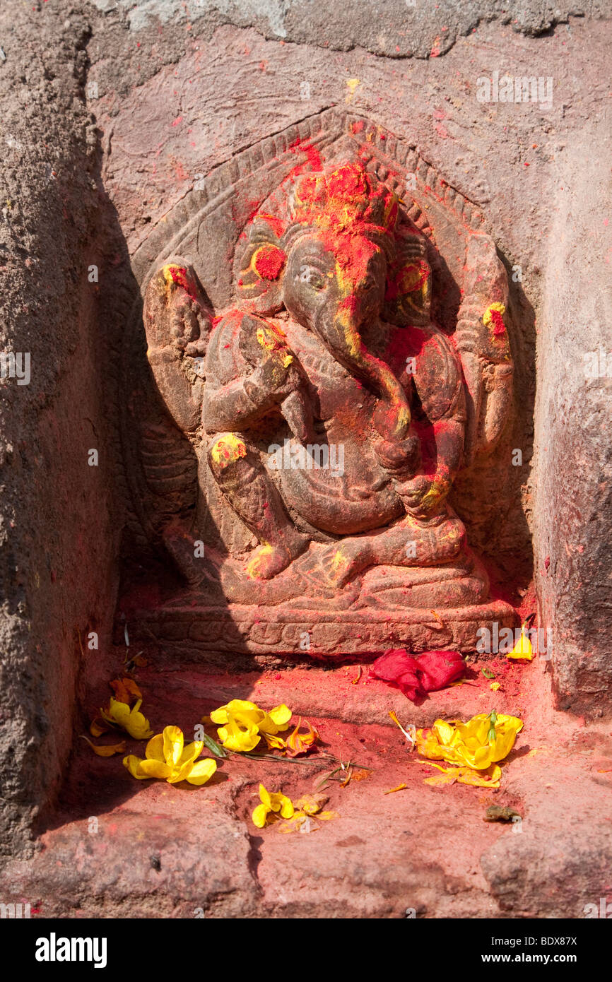 Kathmandu, Nepal. Stone Sculpture of the God Ganesh, with Flowers and Sindur Offerings. Stock Photo