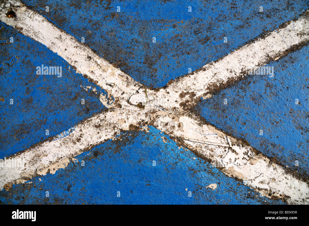 A weather worn painted Scottish saltire on a cement wall. Stock Photo