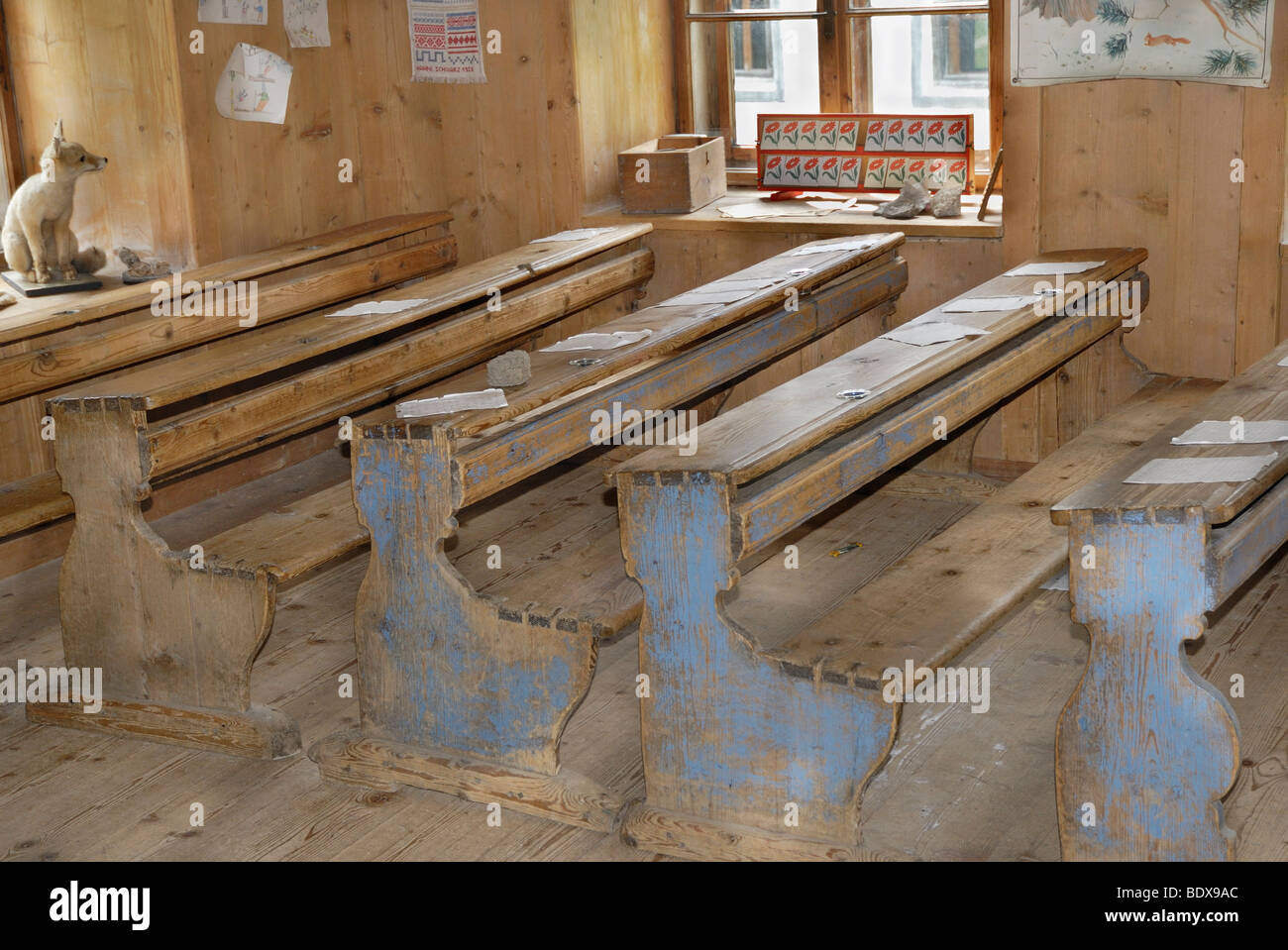 Historic single-class school benches with school books and teaching aids, early 20th century, originally from South Tyrol, Muse Stock Photo