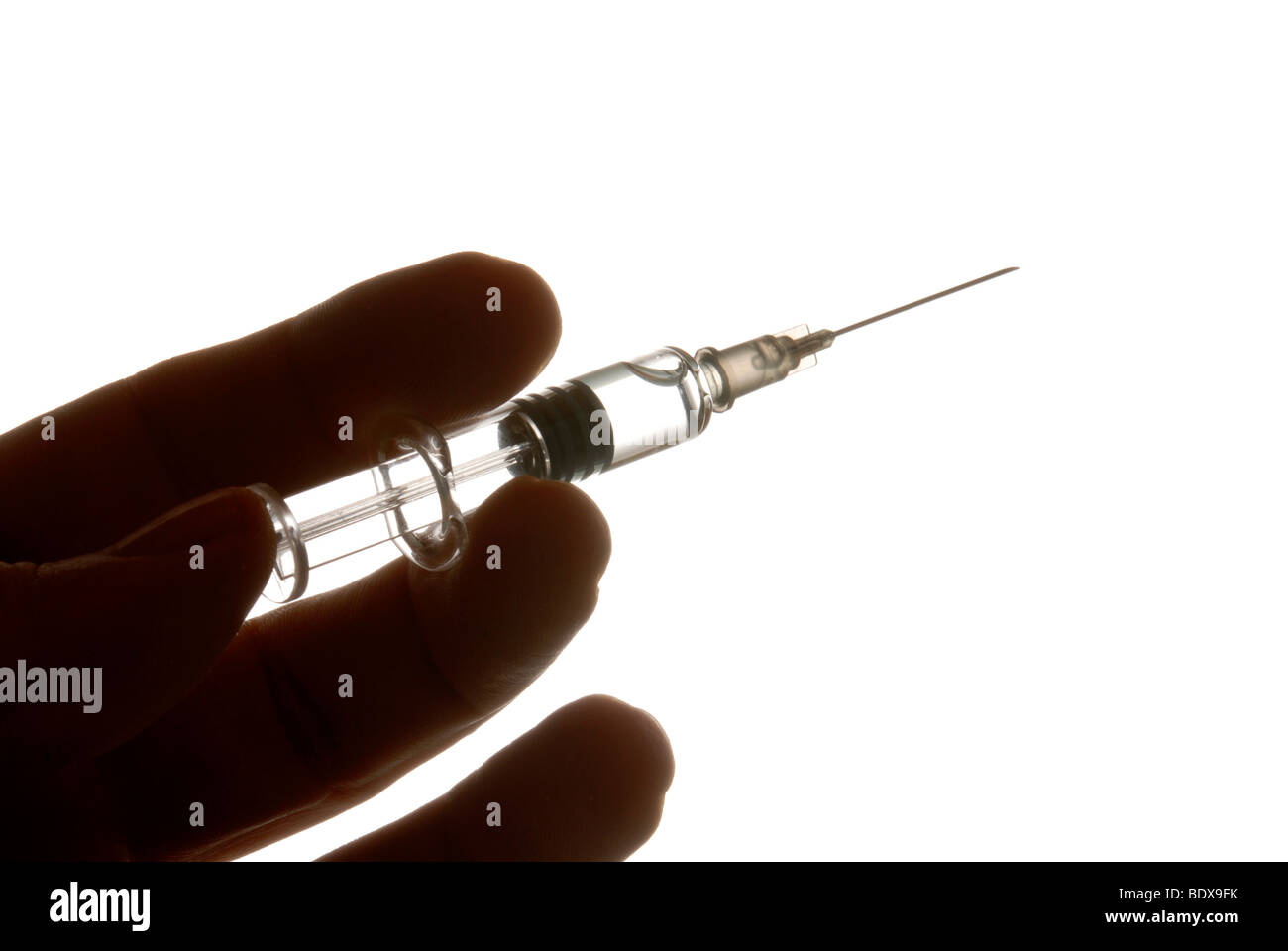 Hand with syringe, symbolic image for flu vaccination Stock Photo