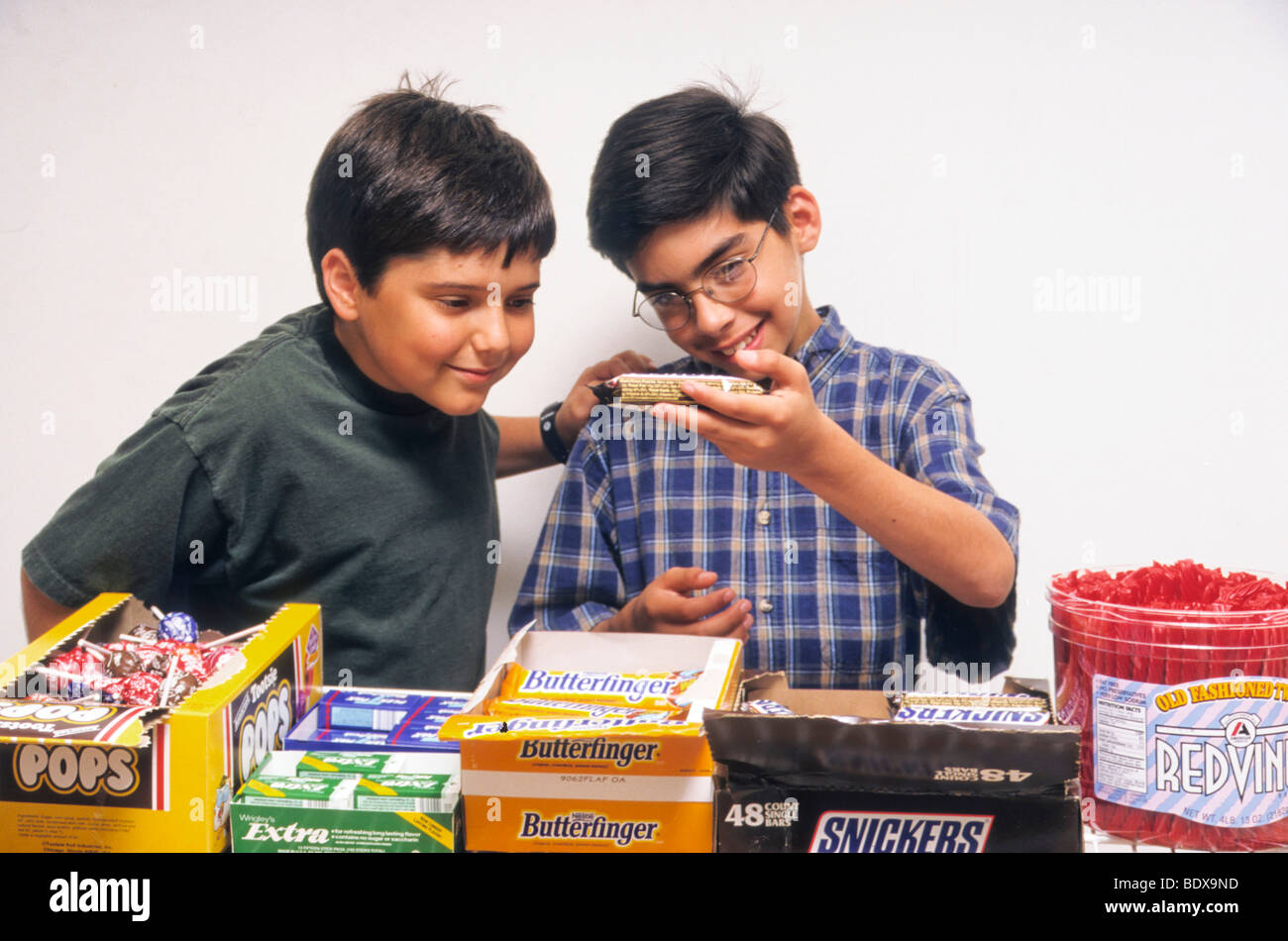 boys read nutrition information on candy bar in store Stock Photo