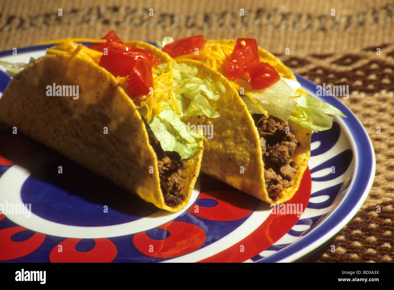 fried corn tortilla lettuce cooked ground beef cheese tomato sauce