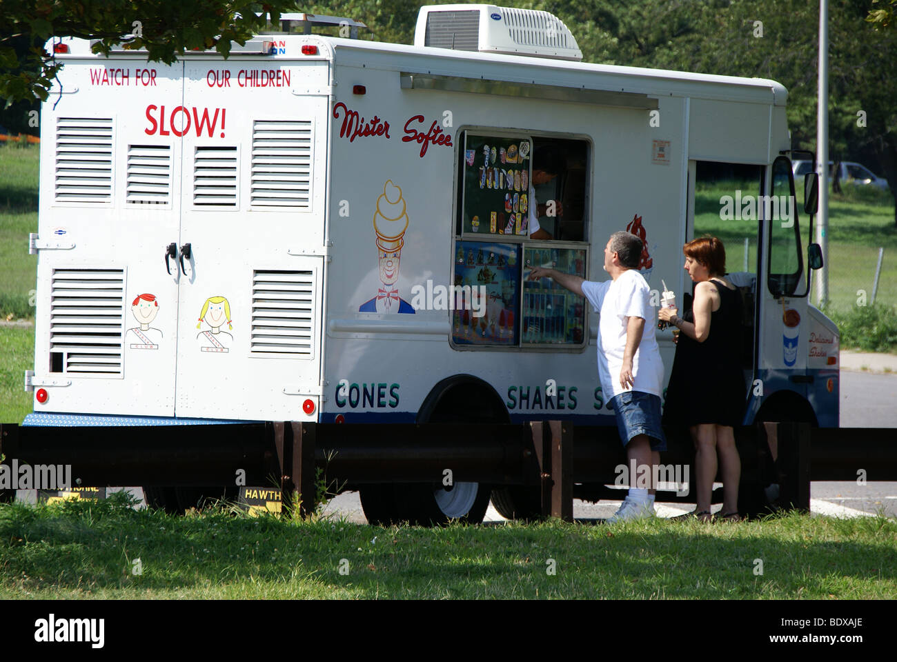 Man and a woman buy icecream  from an icecram truck Stock Photo