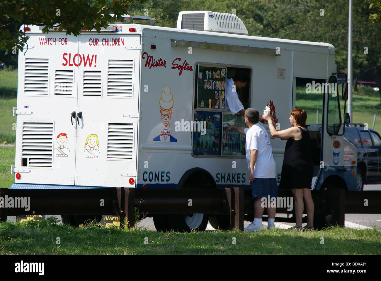 Man and a woman buy icecream  from an icecram truck Stock Photo