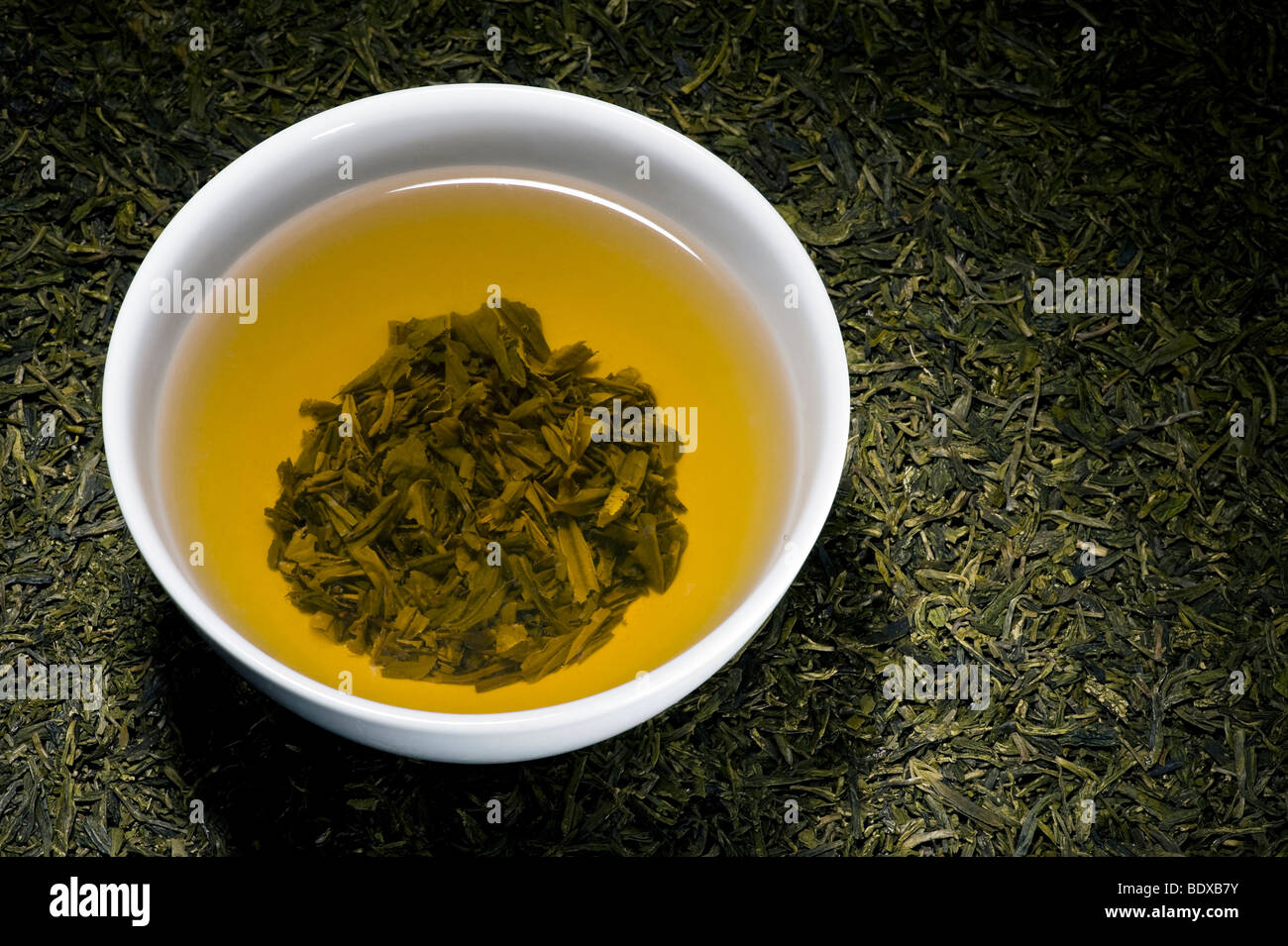 Green tea in tea bowl on dry Longjing tea, Chinese Dragonwell tea Stock Photo