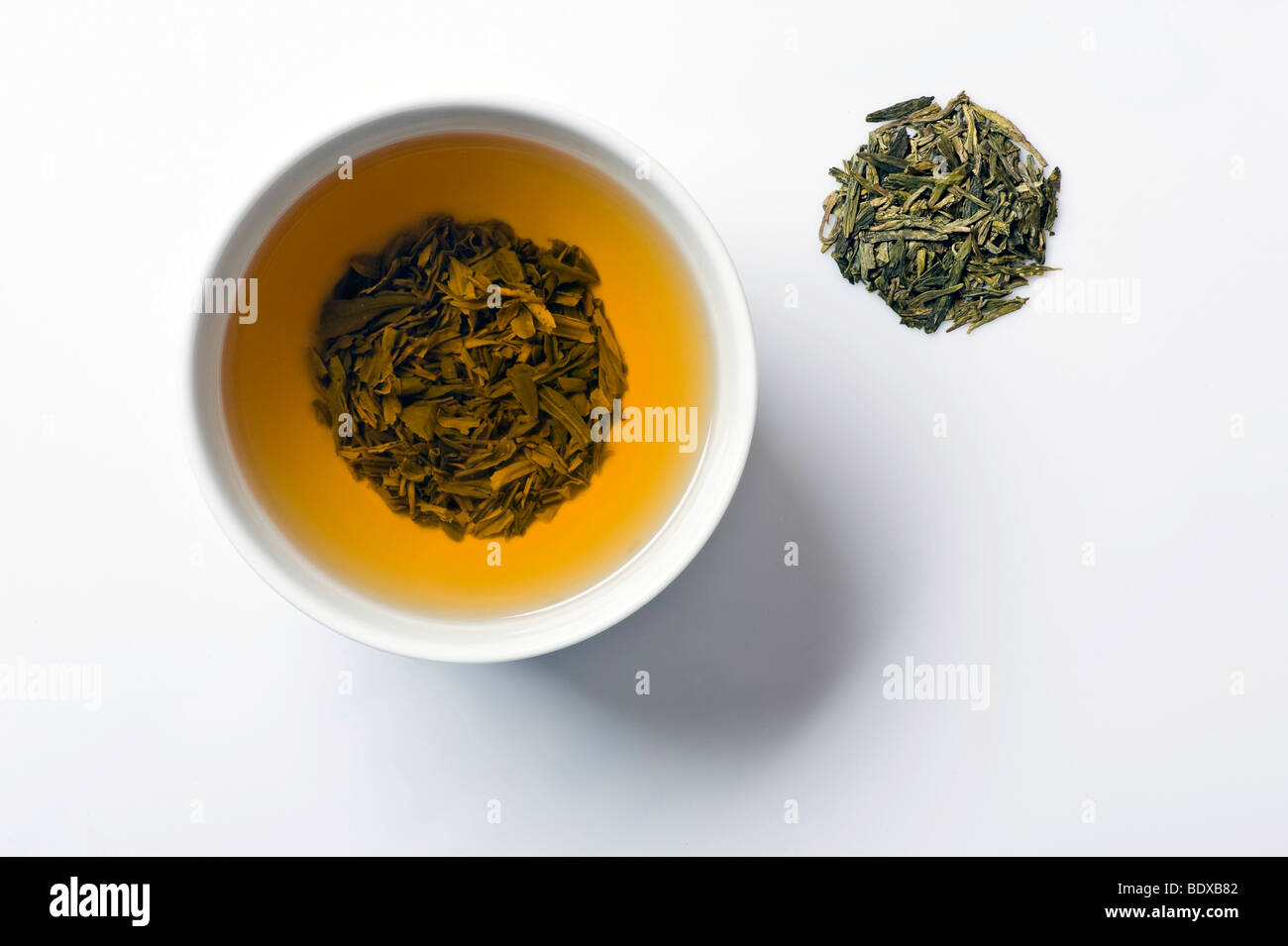 Green tea in tea bowl with dry Longjing tea, Chinese Dragonwell tea Stock Photo