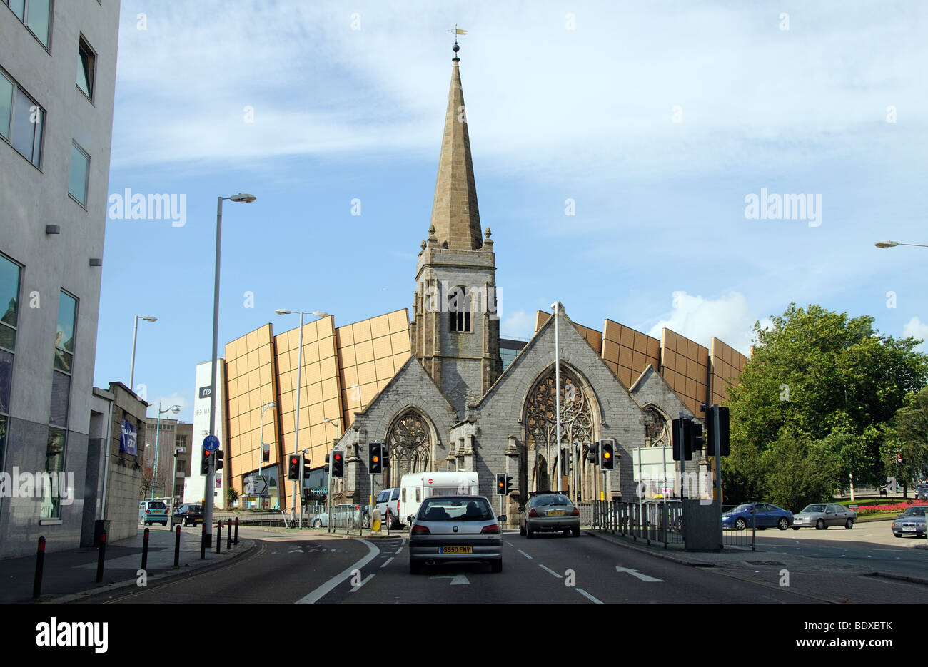 Plymouth city centre Devon England UK Modern shopping centre and a war damaged church Charles Cross Stock Photo