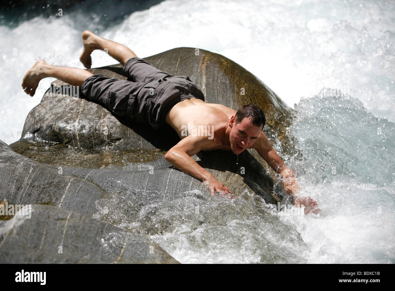 Tourist having fun and cooling off in summer at the rapids of the river Maggia, Ticino, Switzerland, Europe Stock Photo