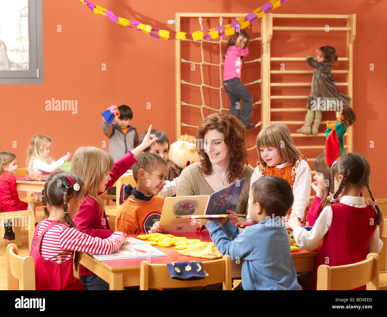 kindergarten teacher playing games with children Stock Photo Alamy