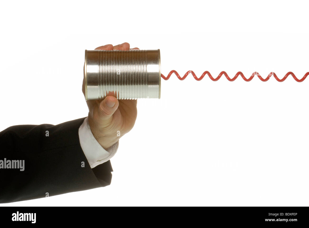 Business man with tin and telephone cable, a symbolic image for communications Stock Photo