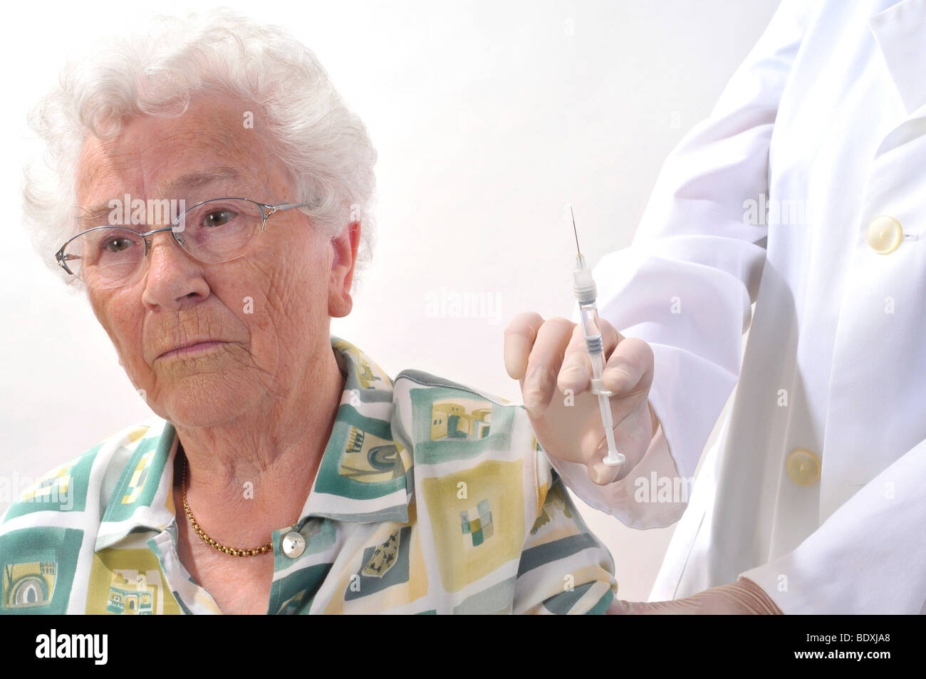 Elderly woman being vaccinated Stock Photo