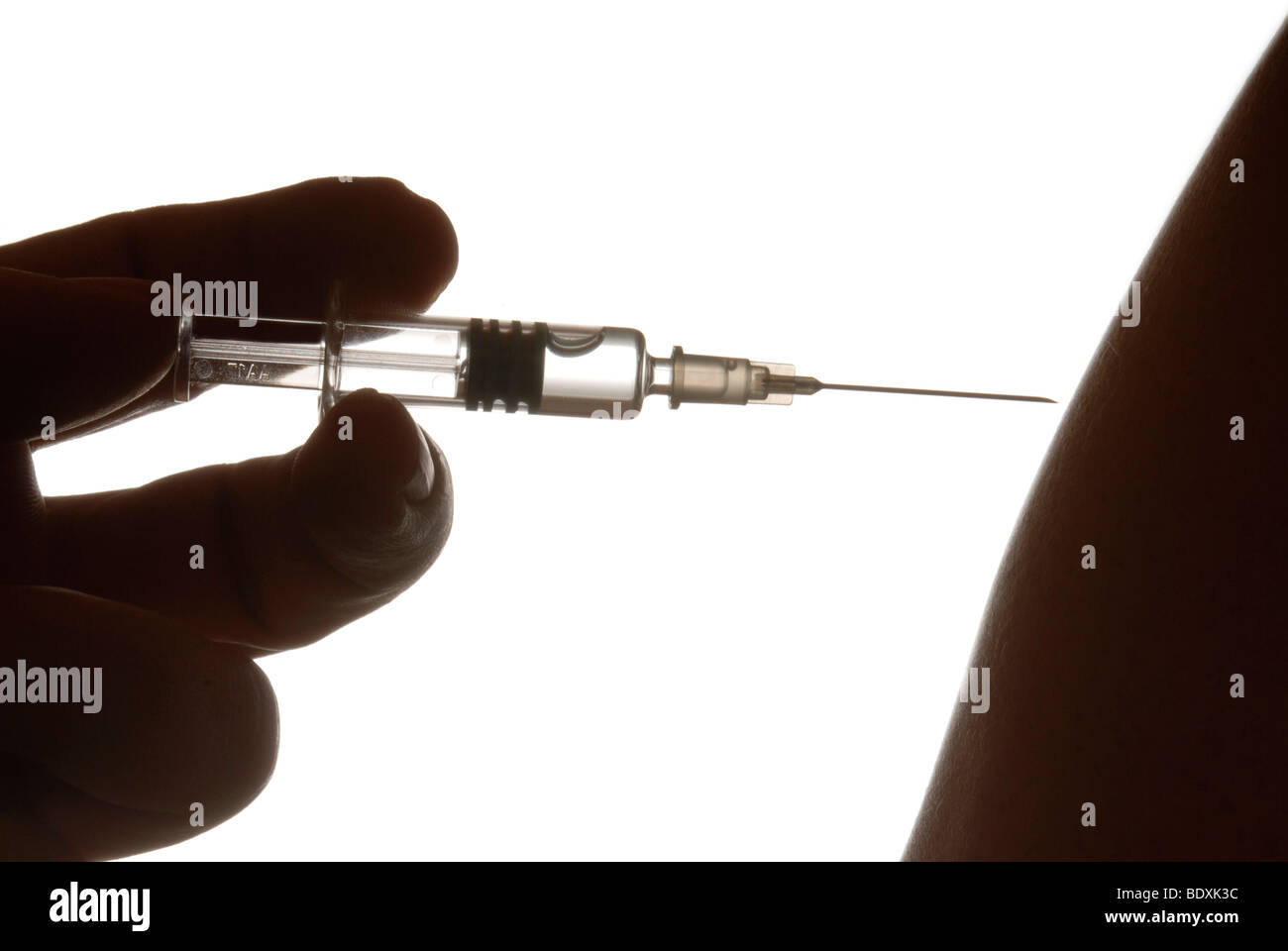 Hand with syringe, symbolic image for flu vaccination Stock Photo