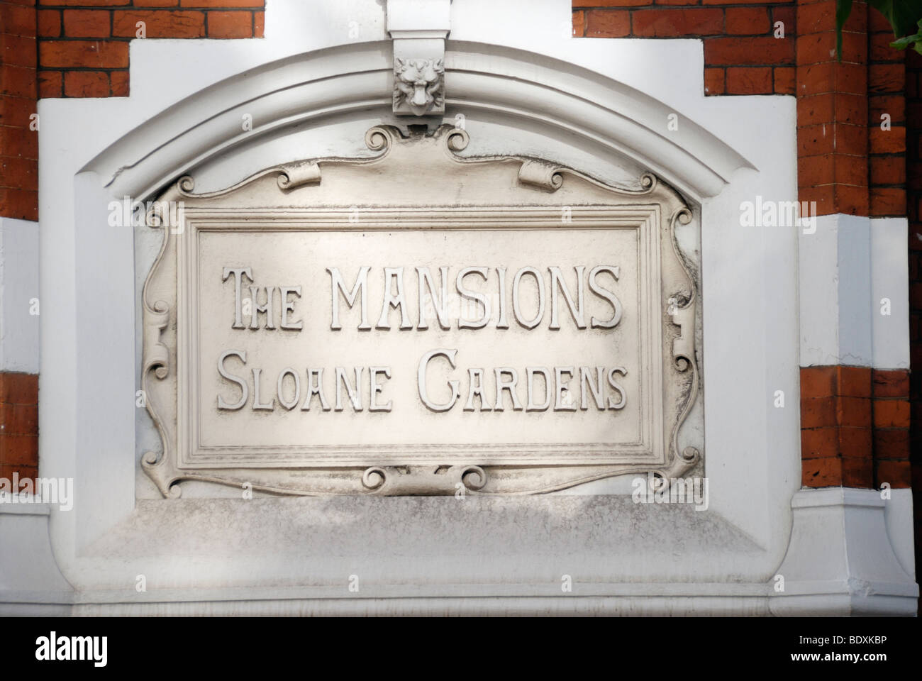 'The Mansions Sloane Gardens' stone plaque set into mansion apartment block wall near Sloane Square, Chelsea, London, UK Stock Photo