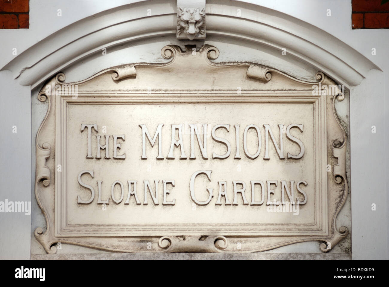'The Mansions Sloane Gardens' stone plaque set into mansion apartment block wall near Sloane Square, Chelsea, London, UK Stock Photo