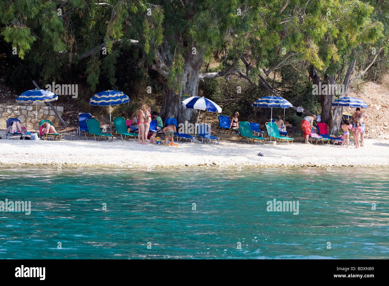 Day at the Beach. Families and Umbrellas. Corfu, Greece. NO Model Release. Stock Photo