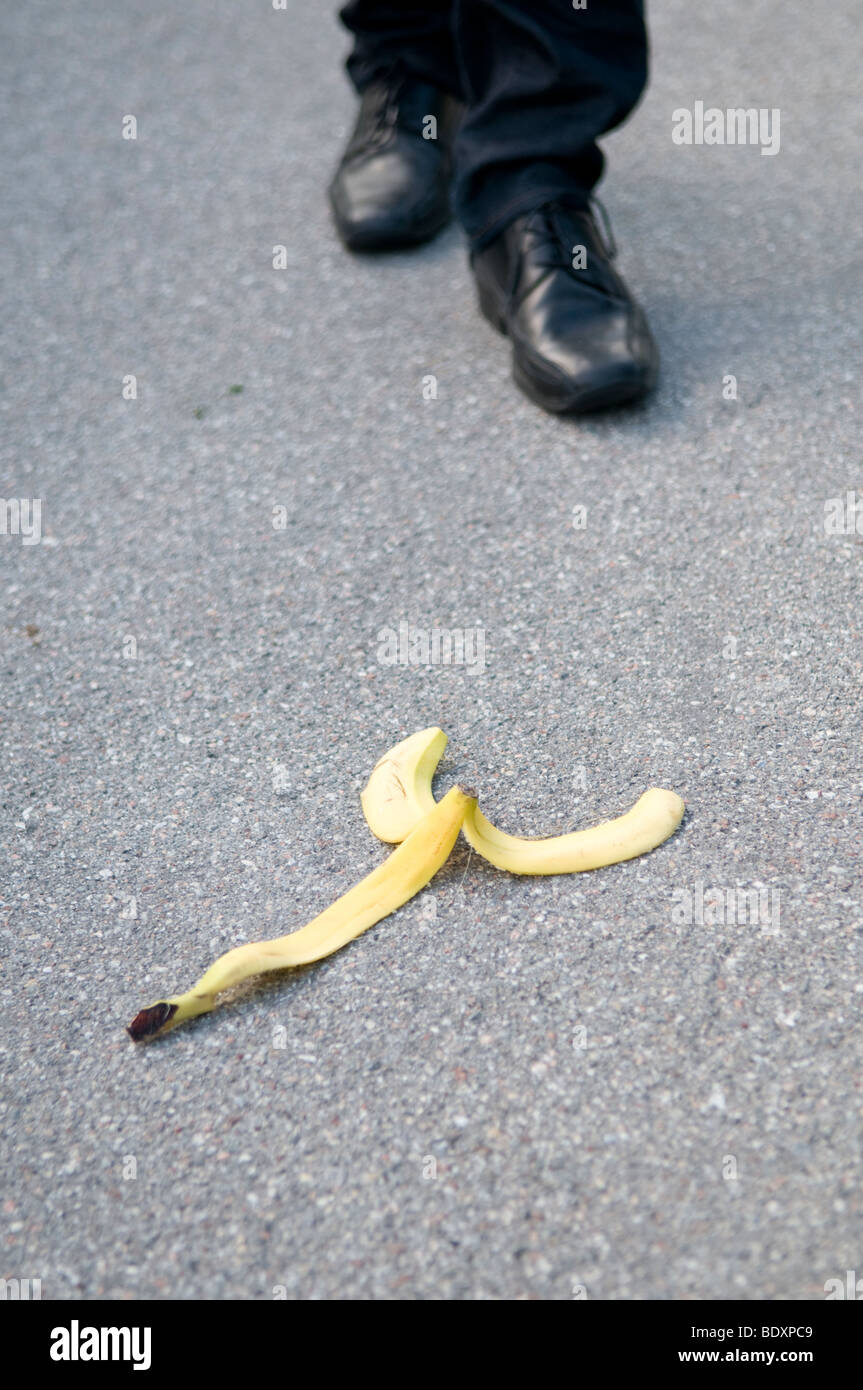 Man walking towards a banana peel on the ground, he will probably slip