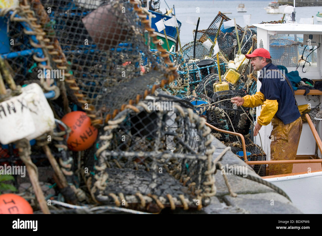 Fisherman loading loobster baskets on his boat before going out fishing