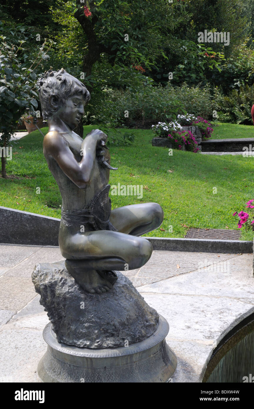 The bronze statue of a young boy fishing in the gardens of the Villa