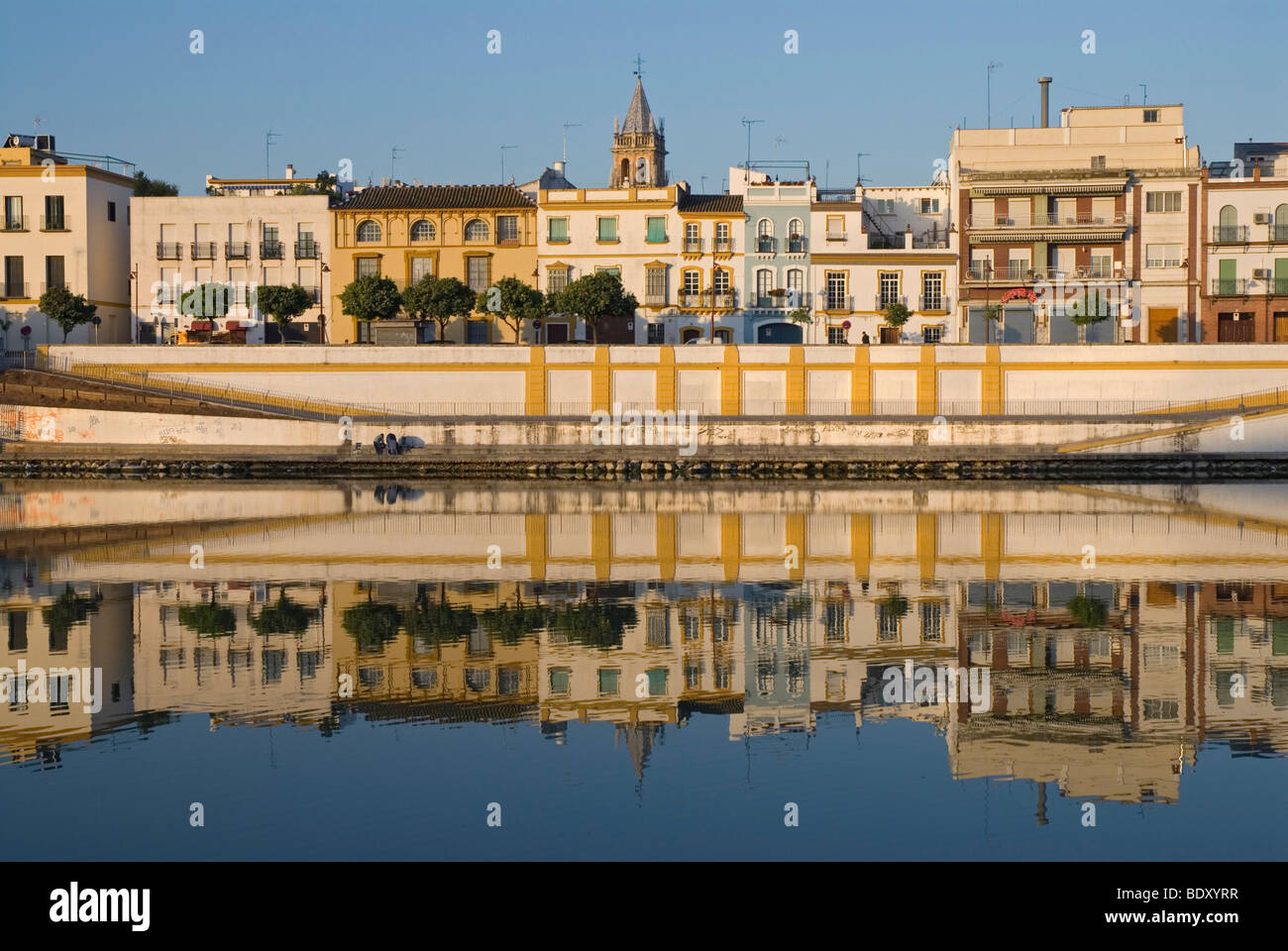 Houses from Triana reflected in the calm waters of the Guadalquivir river, Seville, Spain, Europe Stock Photo