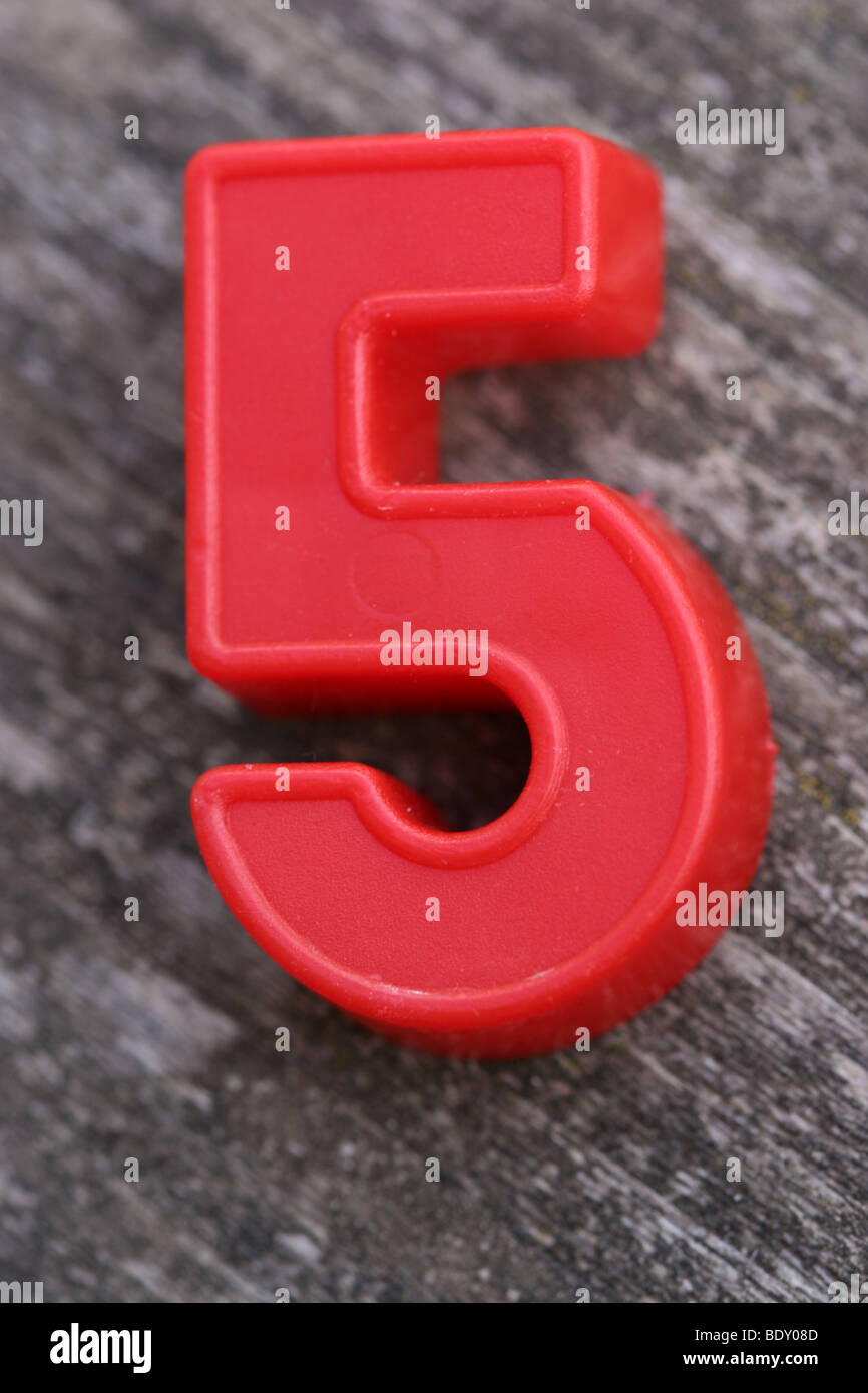 Red magnetic Number Five on wood Stock Photo