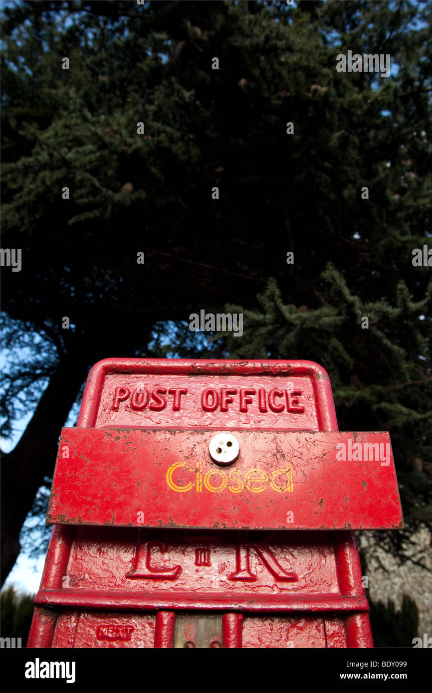 close up of small post office box with "closed" sign over letter box