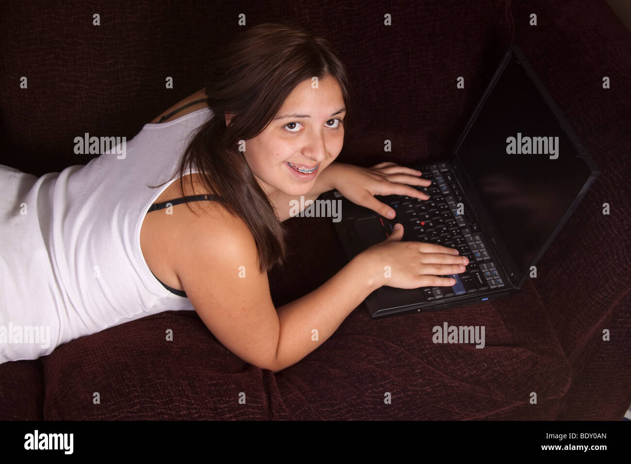 Teen girl laying on sofa hi-res stock photography and images - Alamy