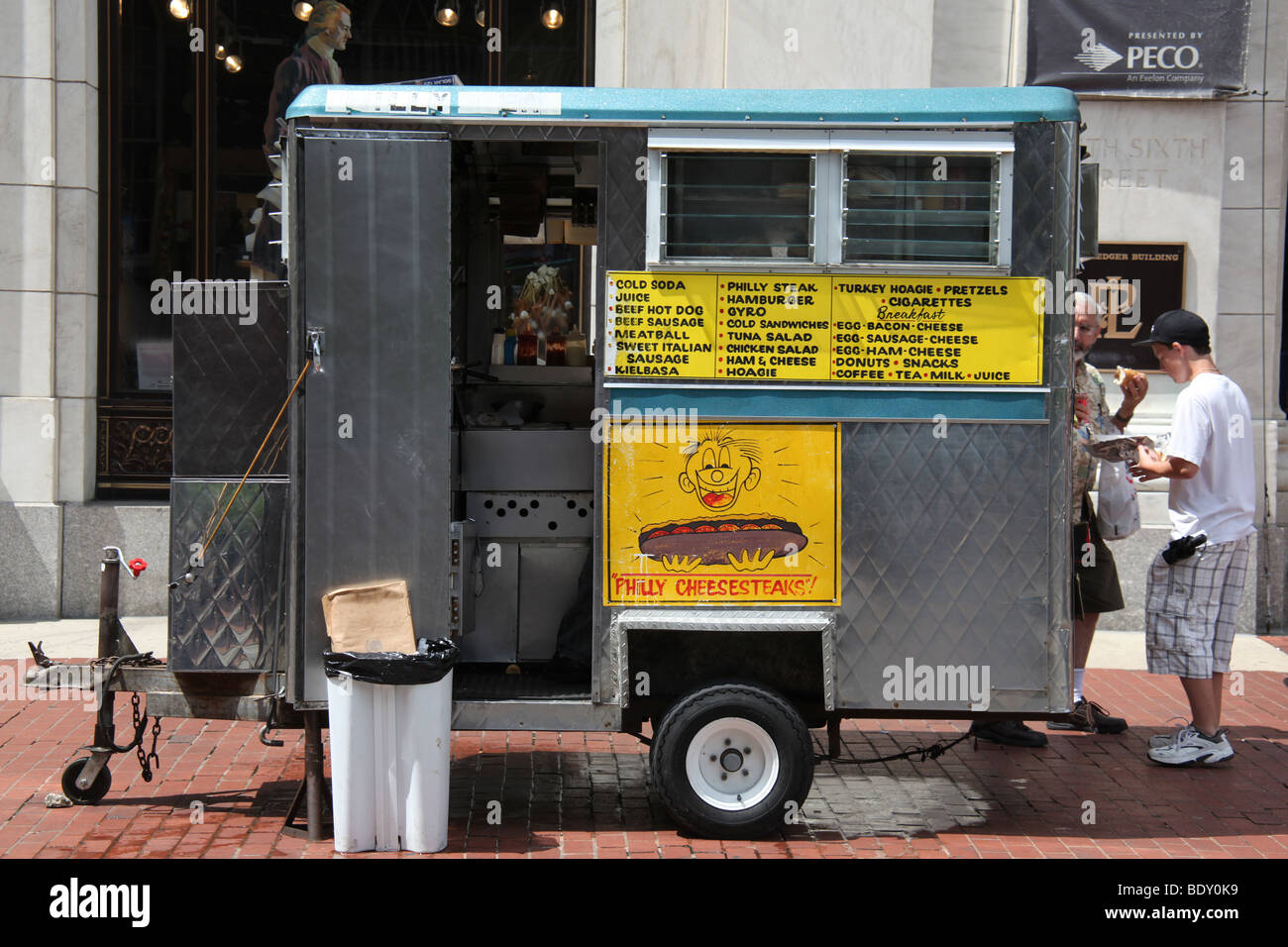 Food vendor selling Philly Cheesesteaks from a food cart in