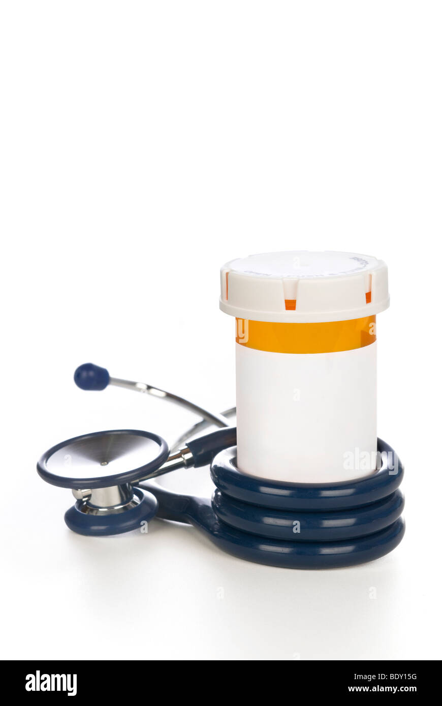 A pill bottle with blank label wrapped by a stethoscope. Stock Photo