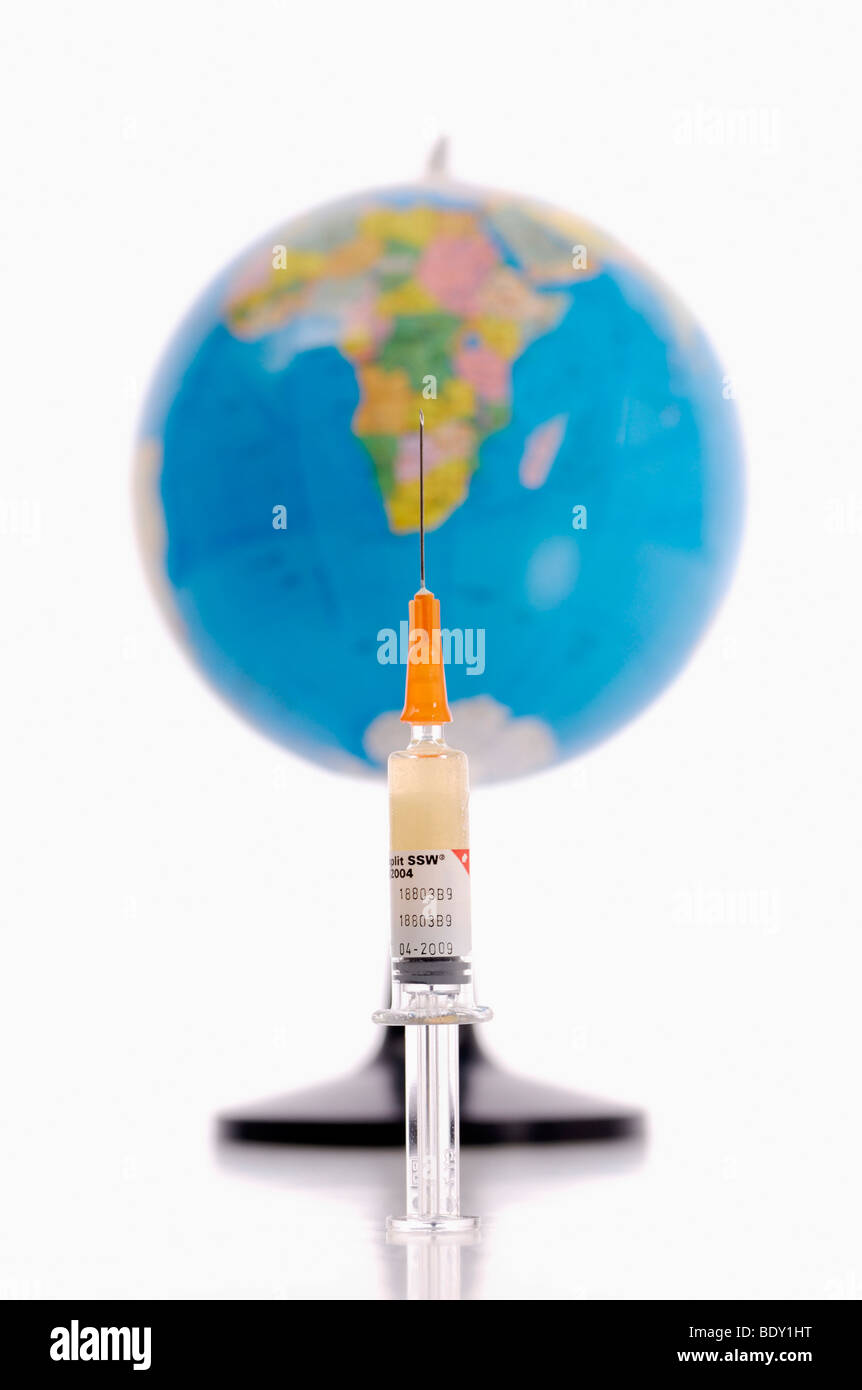 Syringe and globe, symbolic of vaccination against swine flu, pandemic Stock Photo