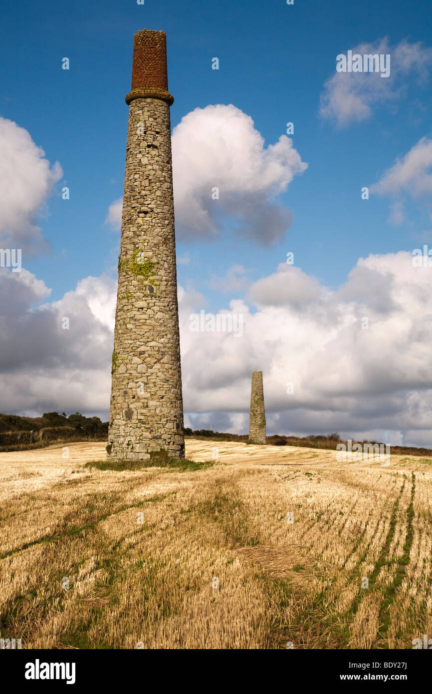 Chimneys left over from tin mining stand in the landscape of Cornwall, UK Stock Photo