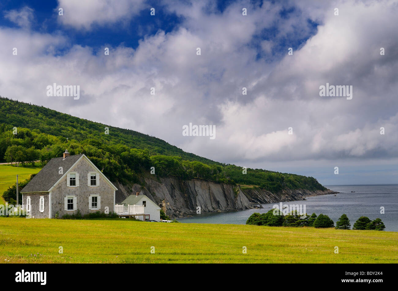 House in small village of Capstick at the north tip of Cape Breton Island Nova Scotia on the coast of the Atlantic Ocean with seaside cliffs Stock Photo