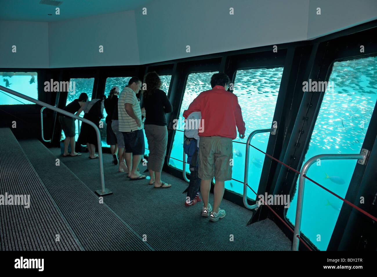 Tourists in an underwater observation chamber on a diving station
