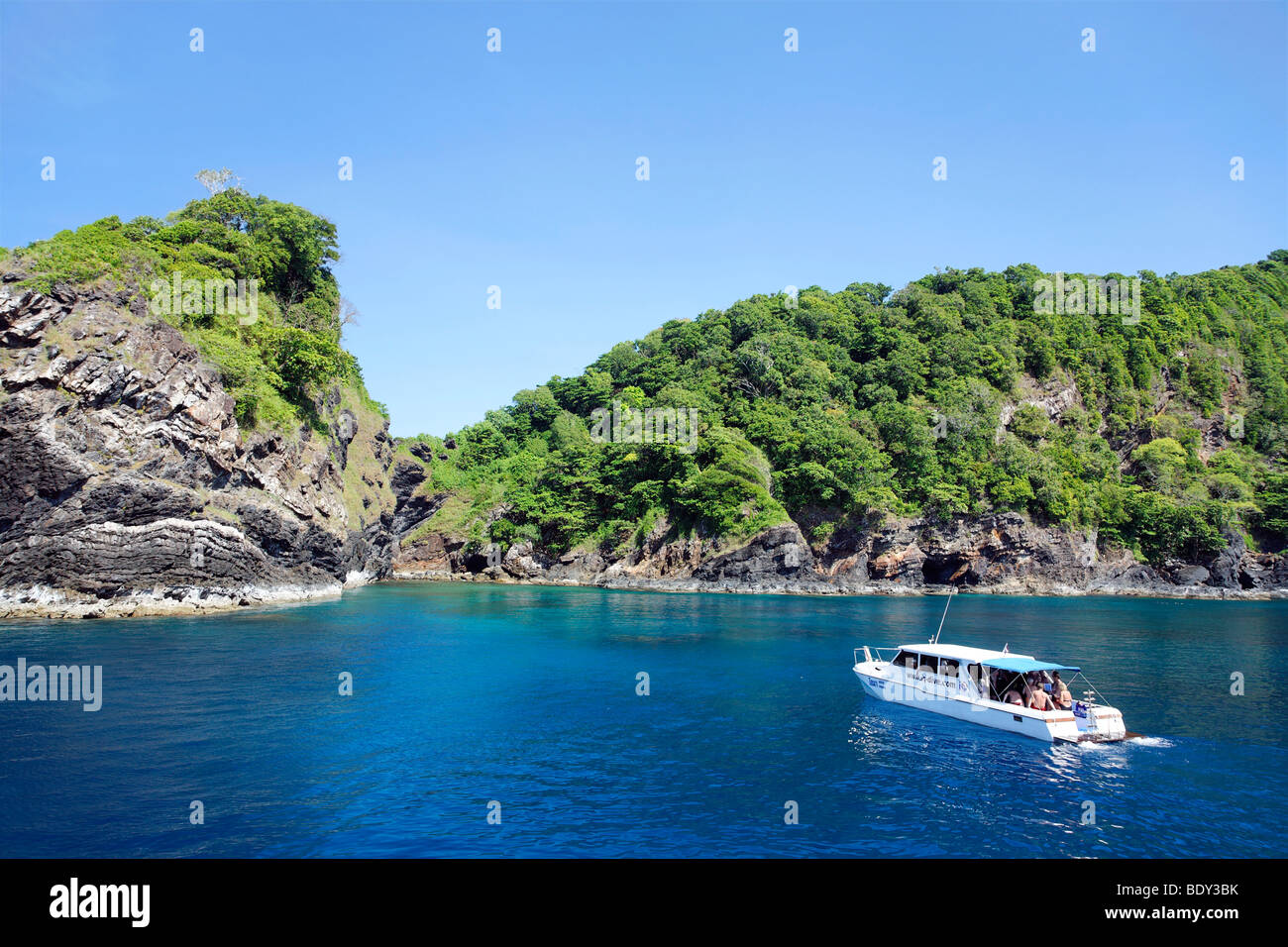 Dive ship anchored in front of green-clad cliffs, Similan Islands, Phuket, Thailand, Andaman Sea, Indian Ocean, Asia Stock Photo